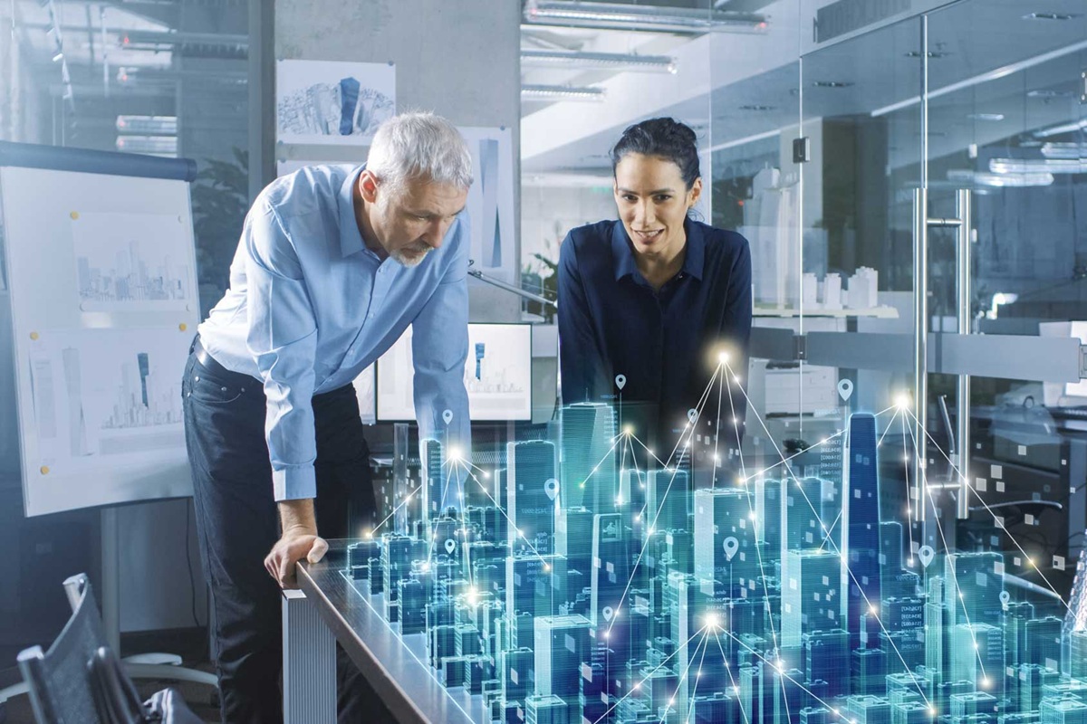 Male and Female Architects Work with Holographic Augmented Reality 3D City Model. Technologically Advanced Office Professional People Use Virtual Reality Modeling Software Application.